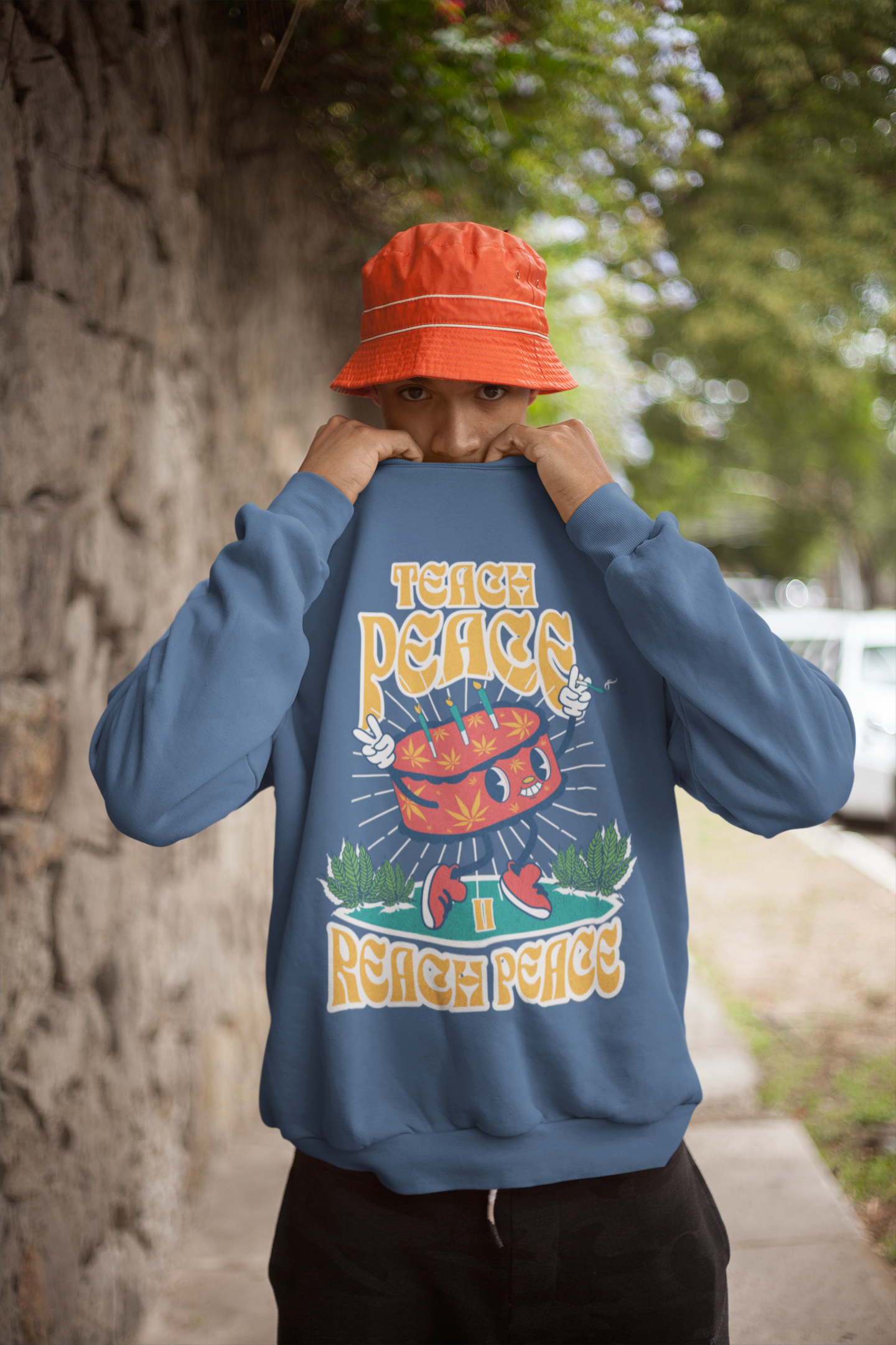 sweatshirt-mockup-of-a-man-covering-his-face-by-a-stone-wall